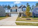 Charming two-story home with a two-car garage, landscaped front yard, and a traditional design at 117 Rooster Tail Ln, Troutman, NC 28166