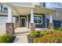 Inviting front porch with stone pillar bases, number 117, and well-maintained landscaping at 117 Rooster Tail Ln, Troutman, NC 28166