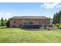 Spacious backyard featuring a large wooden deck perfect for outdoor entertaining with brick barbecue area at 131 Fieldhaven Pl, Troutman, NC 28166