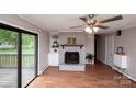 Cozy living room with a brick fireplace and built-in shelving at 134 Piedmont Dr, Kannapolis, NC 28081