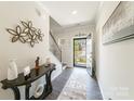 Bright foyer with decor and hardwood floors offers a welcoming entrance to the home at 15520 Capps Rd, Charlotte, NC 28278