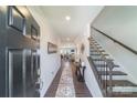 Inviting foyer features stylish floors, a staircase, and a view leading into a cozy living space at 15520 Capps Rd, Charlotte, NC 28278