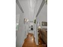 Bright hallway leads to the kitchen and living area with pristine white walls and wood flooring at 16070 Palawan Ct, Tega Cay, SC 29708