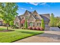 Spacious home with a three-car garage, a well-manicured lawn, and mature landscaping at 17909 Golden Meadow Ct, Davidson, NC 28036