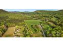 Expansive aerial view of property highlighting home nestled on large lot in lush greenery at 1821 Hopewell Church Rd, Hiddenite, NC 28636