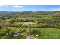 Lush aerial view showing expansive lot, mature trees, and quiet country setting at 1821 Hopewell Church Rd, Hiddenite, NC 28636