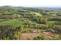 Beautiful aerial view with expansive acreage, mature trees and quiet country setting at 1821 Hopewell Church Rd, Hiddenite, NC 28636