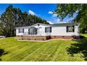 Charming single-story home boasting a covered front porch with black railings and tidy landscaping at 186 Ellendale Ln, Taylorsville, NC 28681