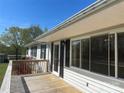 Exterior shot from porch featuring sliding glass doors and black shutters, with wooded background at 1869 Wooten St, Catawba, NC 28673