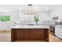 Bright kitchen featuring a large island with quartz countertops and modern appliances at 1904 27Th Avenue Ne Dr, Hickory, NC 28601