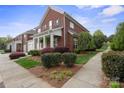 A beautiful brick home with meticulously landscaped grounds showcasing lush greenery and a well-manicured lawn at 20217 Middletown Rd, Cornelius, NC 28031