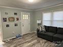 Inviting living room with gray sofa, wood-look floors, neutral paint and natural light from the window at 2122 Hope Dr, Rock Hill, SC 29730
