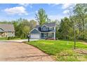 Charming two-story home with blue siding, an attached two-car garage and a well-manicured lawn at 2668 Polo Ln, Maiden, NC 28650