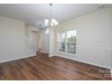 Bright living room with wood floors, large windows, and neutral walls, perfect for entertaining or relaxing at 2684 Sunberry Nw Ln, Concord, NC 28027