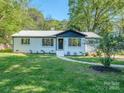 Beautifully renovated home with lush green lawn and fresh landscaping at 2717 Springway Dr, Charlotte, NC 28205