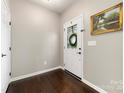 View of entryway featuring hardwood floors, a glass paneled door, and a decorative painting on the wall at 3039 Keswick Ter, Indian Land, SC 29707