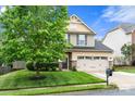 Charming two-story home with stone accents, a well-manicured lawn, and a spacious two-car garage at 3039 Keswick Ter, Indian Land, SC 29707