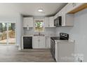 Modern kitchen with white cabinets, stainless steel appliances, and light countertops, offering a sleek and functional space at 313 Villa St, Kannapolis, NC 28083