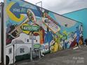 Colorful mural featuring local themes and landmarks on the side of the building at 3824 Freedom Dr, Charlotte, NC 28208