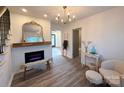 Inviting living room features modern lighting, a decorative fireplace and mantle, and hardwood style floors at 401 Baker St, Gastonia, NC 28052