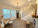 Bright living room with hardwood floors, large windows, and modern chandelier at 401 Baker St, Gastonia, NC 28052