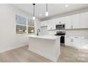 Modern kitchen with white cabinets, stainless steel appliances, and a center island at 405 Durham Ave, Statesville, NC 28677