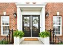 Inviting double front doors accented with wreaths and decorative lanterns create a warm welcome at 548 Fairwoods Dr, Huntersville, NC 28078