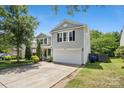 Charming home featuring a well-kept lawn, and a convenient two-car attached garage at 5611 Hammermill Dr, Harrisburg, NC 28075