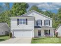 Charming two-story home featuring a two-car garage, neat landscaping, and a welcoming front porch at 599 Annalinde Ln, Rock Hill, SC 29732