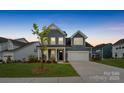 Charming two-story home with blue siding, a two-car garage, and a welcoming front porch in a well-kept neighborhood at 6114 Alsace Ln, Indian Land, SC 29707