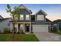 Charming two-story home with blue siding, a two-car garage, and a welcoming front porch in a well-kept neighborhood at 6114 Alsace Ln, Indian Land, SC 29707