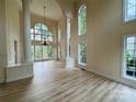 Bright living room boasts tall windows, hardwood floors, and elegant architectural columns at 6316 Glengarrie Ln, Huntersville, NC 28078