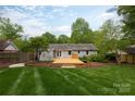 Beautifully landscaped backyard featuring a new wooden deck, perfect for outdoor entertaining at 6701 Highbrook Dr, Charlotte, NC 28212