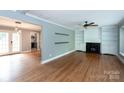 Spacious living room featuring built-in bookcases, fireplace and open layout for entertaining at 6701 Highbrook Dr, Charlotte, NC 28212