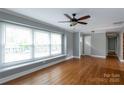 Inviting living room with large windows that flood the space with natural light and beautiful hardwood floors at 6701 Highbrook Dr, Charlotte, NC 28212