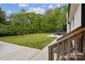 Spacious backyard featuring a concrete patio, swing set, and plenty of green space at 7200 Monroe Rd, Charlotte, NC 28212