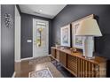 Inviting entryway with wood floors, dark walls, stylish console table, and decorative artwork at 8018 Green Heron Ct, Belmont, NC 28012