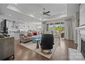 Spacious living room features hardwood floors, large windows, a fireplace, and stylish furnishings at 8018 Green Heron Ct, Belmont, NC 28012