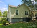 Rear view of a home highlighting neutral siding, updated windows, and a well-maintained lawn at 83 Tribune Sw Ave, Concord, NC 28025