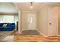 Bright foyer featuring wood floors and a decorative front door with glass at 10316 Whitethorn Dr, Charlotte, NC 28277