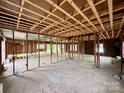 Exposed beams and studs reveal the raw potential of this home renovation project at 104 E Church St, Dallas, NC 28034