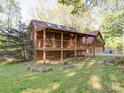 A wood home featuring a large porch with a sunburst wooden railing and a partially finished basement at 110 Dutch Creek Rd, Rockwell, NC 28138