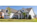 Attractive home showcasing manicured landscaping, a covered porch, and a two-car garage at 13063 Arnold Palmer Cir # 839, Lancaster, SC 29720