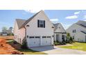 Well-maintained home with an attached two-car garage, neat landscaping, and inviting curb appeal at 13063 Arnold Palmer Cir # 839, Lancaster, SC 29720