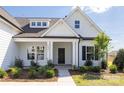 Inviting front entrance with manicured landscaping and an elegant covered porch at 13063 Arnold Palmer Cir # 839, Lancaster, SC 29720