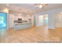 Open concept living space showcasing the kitchen and dining room, and hardwood floors at 13063 Arnold Palmer Cir # 839, Lancaster, SC 29720