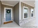 Close up of front entrance with welcoming wreath and craftsman style door at 13279 Arnold Palmer Cir # 867, Lancaster, SC 29720