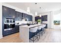 Stylish kitchen featuring a large island with seating, pendant lighting, and modern appliances at 13279 Arnold Palmer Cir # 867, Lancaster, SC 29720