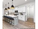 Bright kitchen featuring white cabinets, quartz countertops, and breakfast bar at 13279 Arnold Palmer Cir # 867, Lancaster, SC 29720
