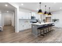 Modern kitchen with gray island, white cabinetry, and pendant lighting at 13279 Arnold Palmer Cir # 867, Lancaster, SC 29720